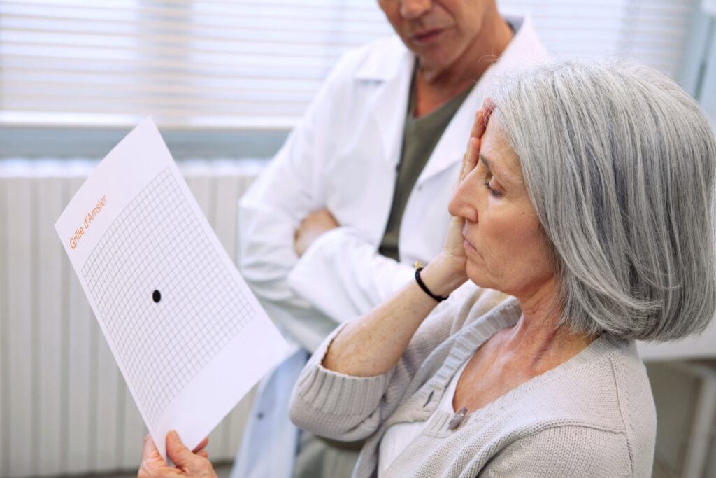Older woman receiving eye exam to diagnose macular degeneration