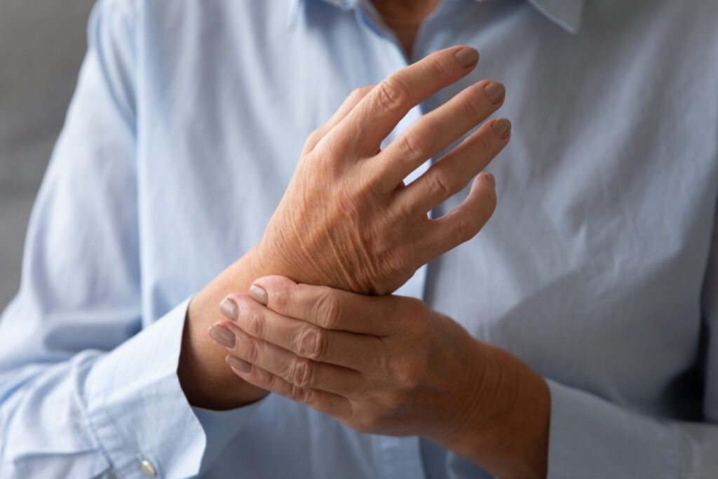 Older woman holding her wrist in pain