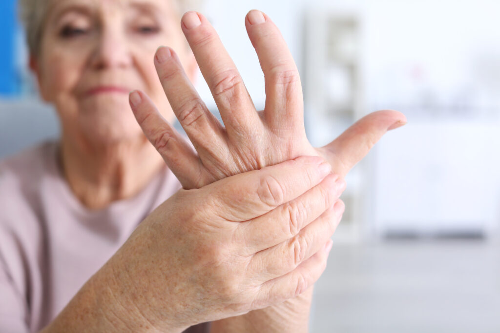 Elderly woman suffering from pain in hand, closeup.