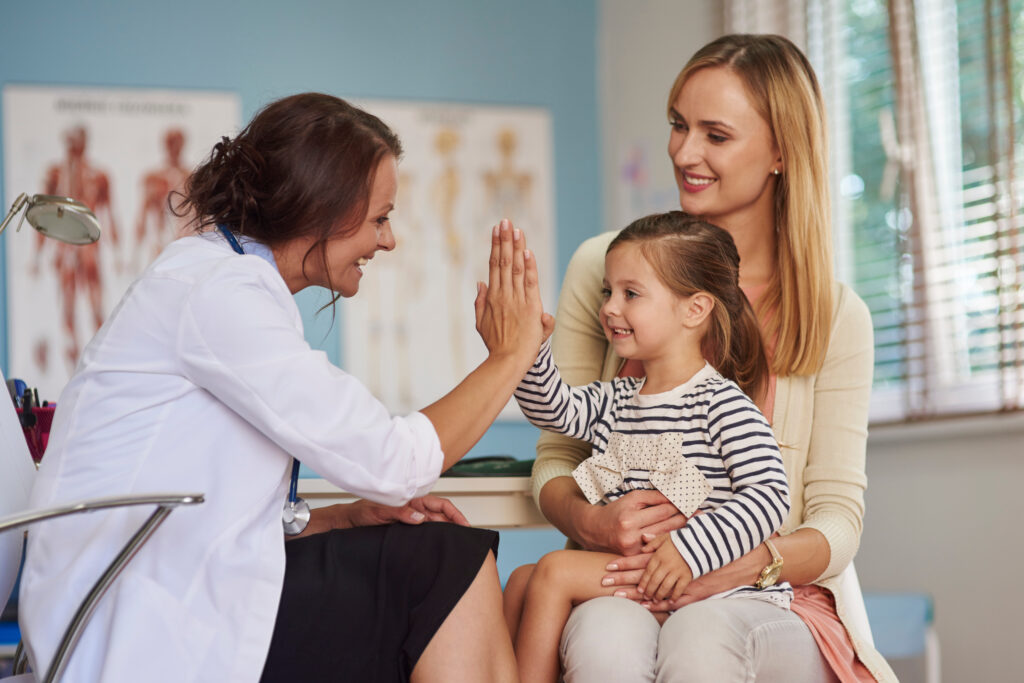 Mother and daughter meeting with a family doctor in a clinic